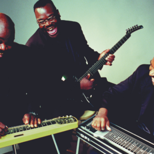 Three of the Campbell Brothers playing the pedal steel guitar, lap steel, and electric guitar.