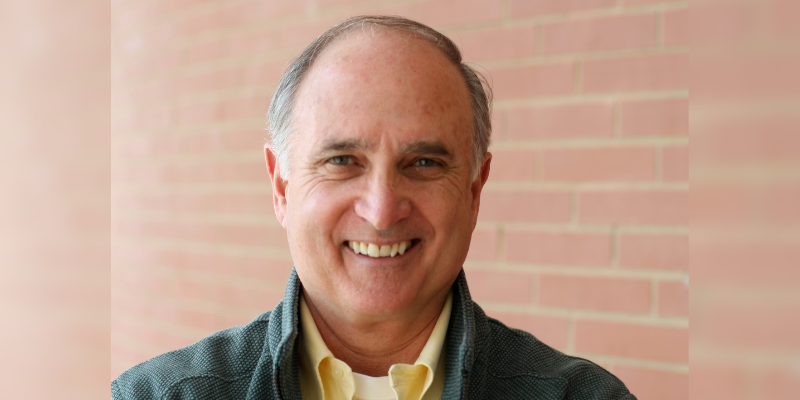 Headshot of David Orr (with grey hair, light skin, and dark green jacket)