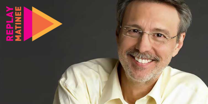 Headshot of Thom Hartmann (with short grey hair, facial hair, and glasses) smiling in front of a dark grey background. Replay Matinee logo is in the upper left corner.