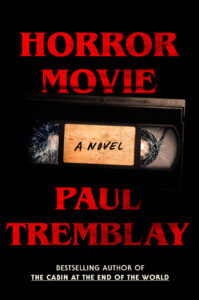 Book cover: Black background with the title "Horror Movie" at the top in red text. A black VHS tape is below labeled "A Novel."