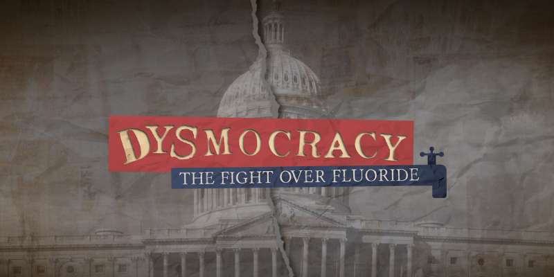 A torn black and white page with a picture of a government building. The words "Dysmocracy: The Fight over Fluoride" are added in the middle as torn pieces of paper.