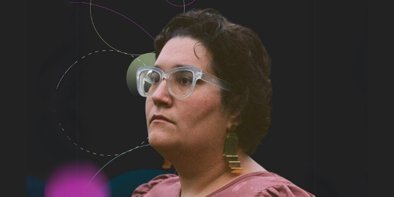 Carmen Maria Machado (with short curly hair, glasses, and pink top) looks to the side against a dark background with abstract lines/shapes.