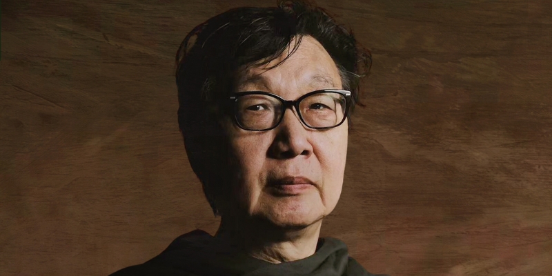 Headshot of Professor Xu Zidong (with fair skin, short black hair, glasses, and black jacket)