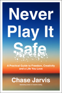 Cover of the book 'Never Play It Safe' by Chase Jarvis. The title is in bold white text on a gradient background transitioning from blue to orange, resembling a clear body of water at sunset. A portion of the word 'Safe' appears shattered. The subtitle reads 'A Practical Guide to Freedom, Creativity and a Life You Love' in smaller white text. The author's name is at the bottom.