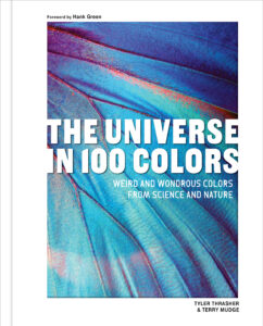 Book cover for "The Universe in 100 Colors" by Tyler Thrasher and Terry Mudge, featuring a close-up image of vibrant blue and purple iridescent scales of a butterfly wing. The subtitle reads, "Weird and Wondrous Colors from Science and Nature."