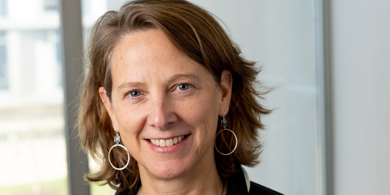 Headshot of Mariana Chilton (with fair skin, brown bob, and dangling hoop earrings)