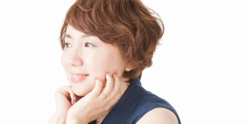 Headshot of Tomoka Shibasaki (with fair skin, short brown hair, and sleeveless collared navy blouse)