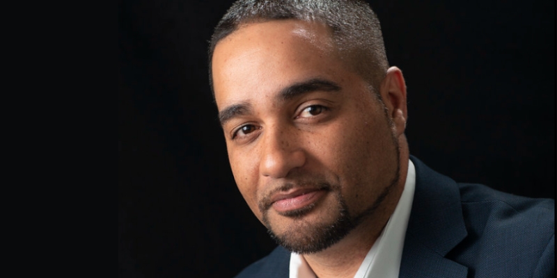 Headshot of Jesse Hagopian (with brown skin and black buzzcut with facial hair)