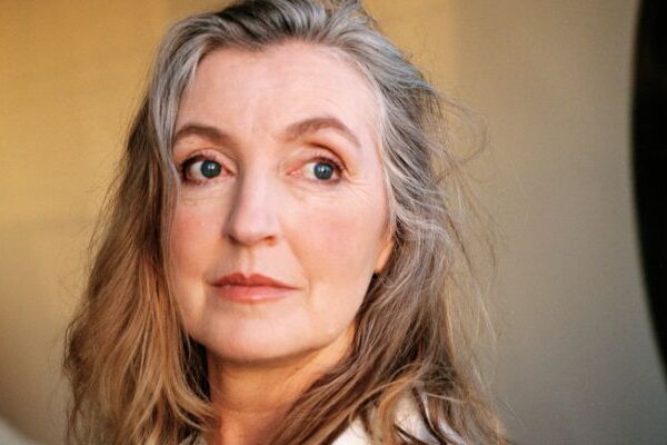 Rebecca Solnit, with long gray hair, looks at the camera