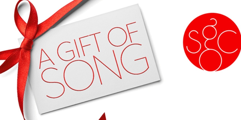 White banner graphic with a red ribbon-wrapped card reading 'A Gift of Song.' A red circular logo with 'SGC' initials appears on the right.