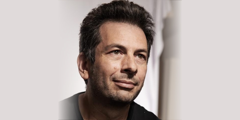 Headshot of Blaise Aguera y Arcas (with light skin, short brown hair, and black shirt)