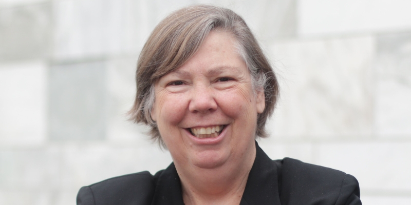 Headshot of Judith Enck (with fair skin, short chin-length grey hair, and black blazer)