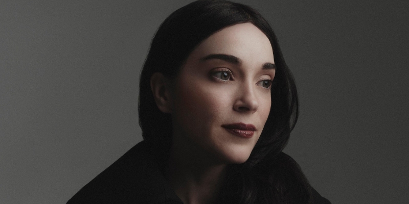 Headshot of St. Vincent (with fair skin, long black hair)