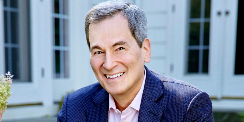 Headshot of David Pogue (with fair skin, short grey hair, and navy suit jacket)