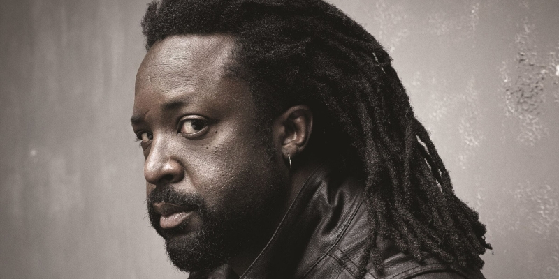 Headshot of Marlon James (with dark skin, beard, and textured hair locs)