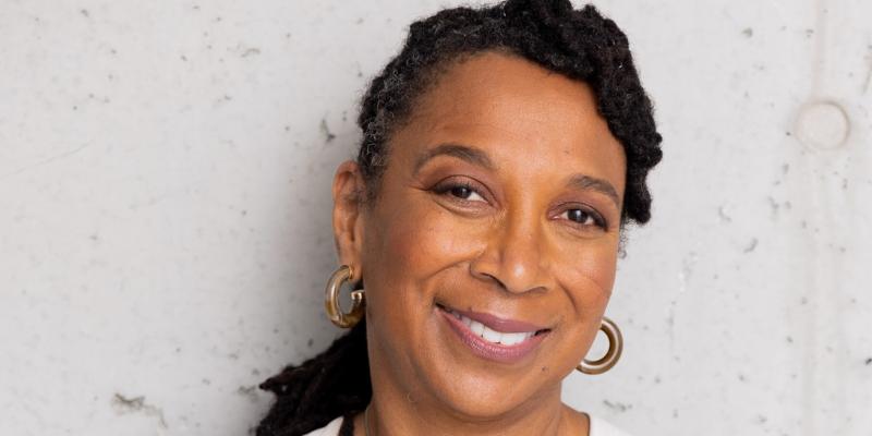 Headshot of Kimberle Crenshaw (with brown skin and black hair twists in a ponytail)