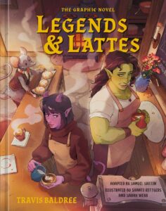 Cover of the graphic novel "Legends & Lattes" by Travis Baldree, featuring a green-skinned orc and a purple-skinned demon working in a cozy café, with a mouse arranging baked goods in the background.