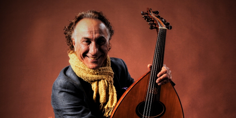 Headshot of Rahim AlHaj holding an oud
